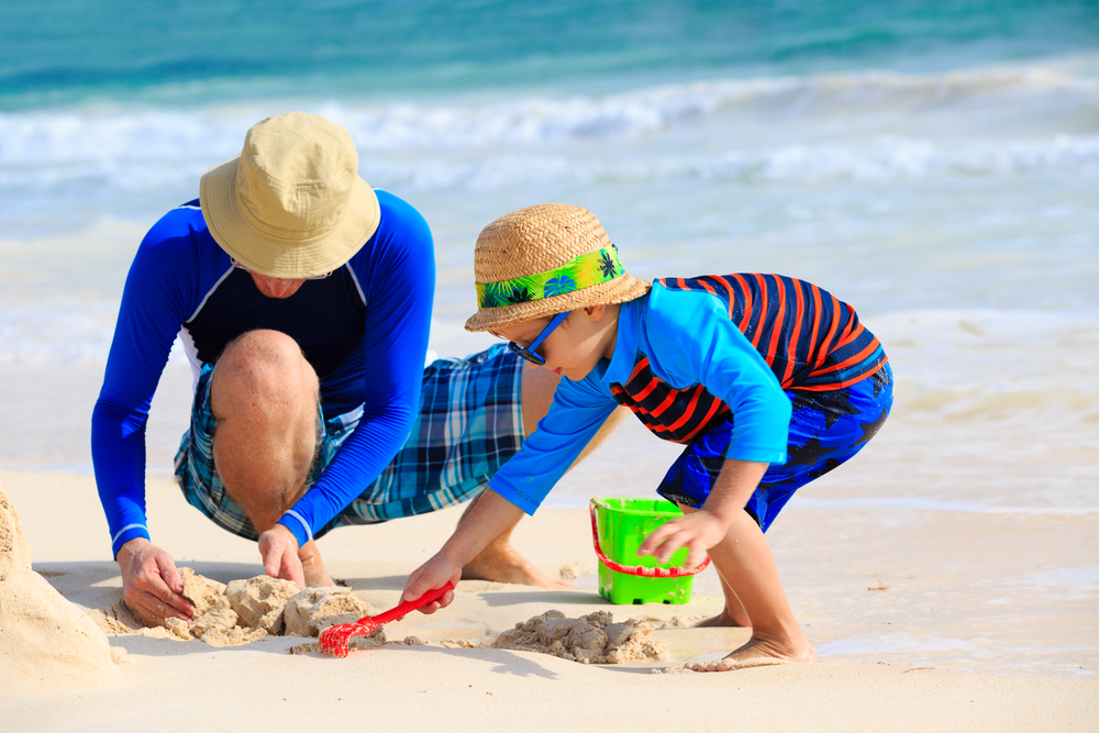 Father and Son Building Sandcastles on the Beach