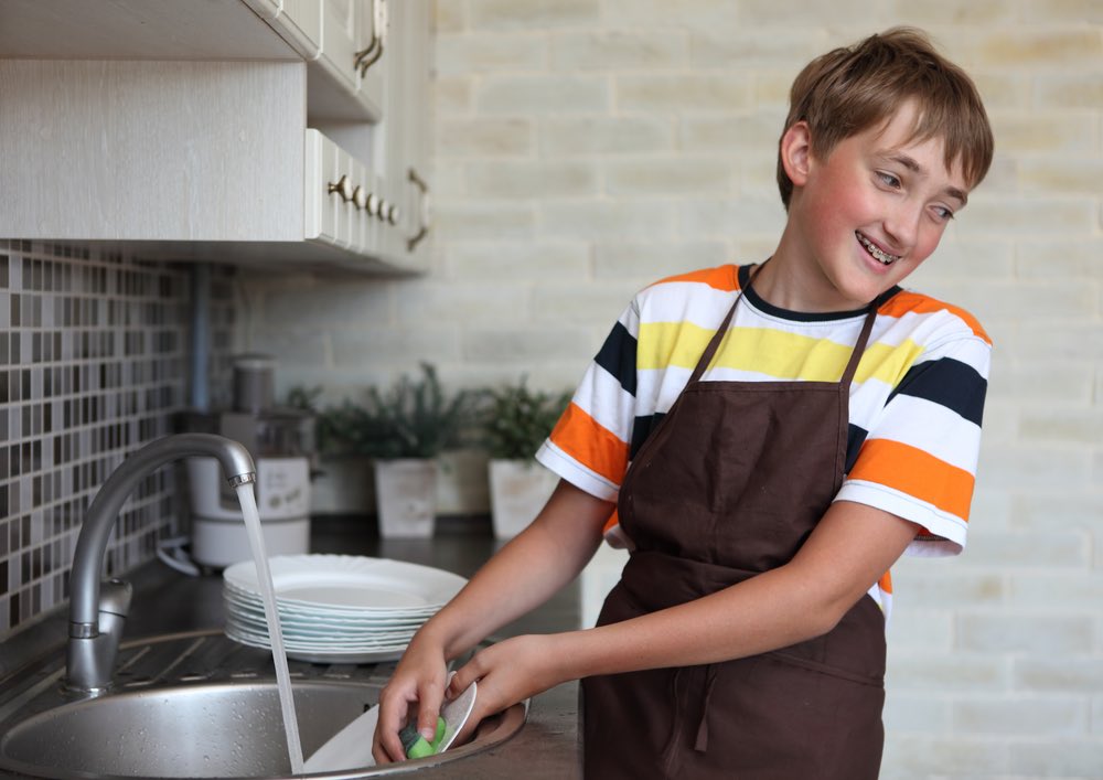 Teen Doing Dishes Smiling