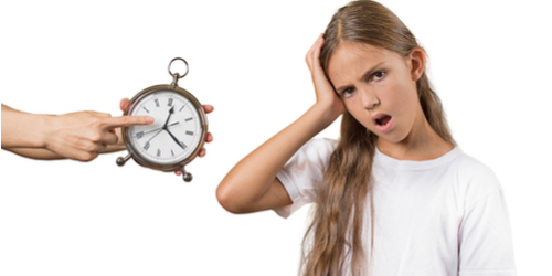 Mom showing daughter clock it's late to go to bed