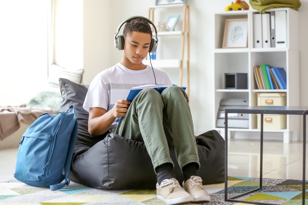 Help Child with ADHD Bean Bag Boy doing homework sitting on bean bag