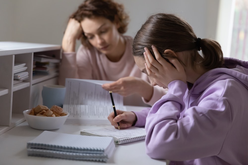 Help Child with ADHD Frustrated Teen Frustrated Teen Studying Mom in Background