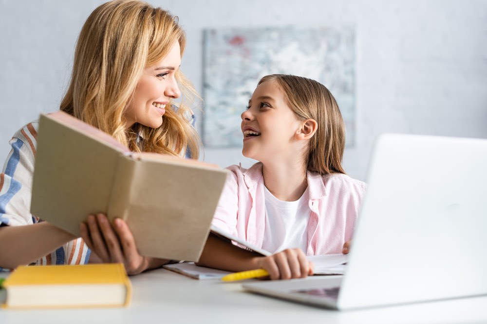 Help Child with ADHD Motivate Mother and Daughter laughing and reading
