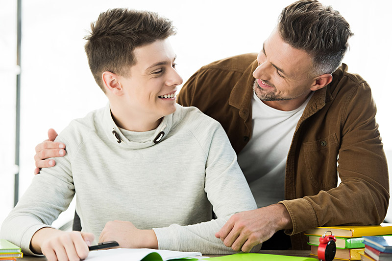 Father with Older Son doing Homework